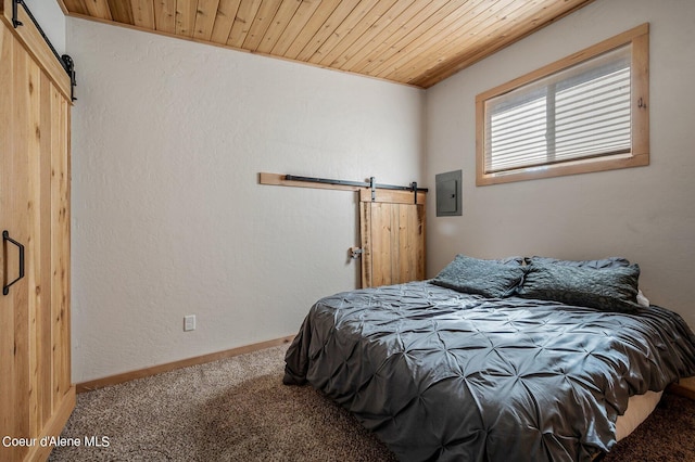 carpeted bedroom featuring a barn door and wood ceiling