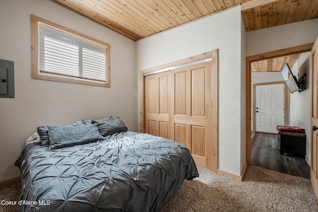 carpeted bedroom with wood ceiling and a closet