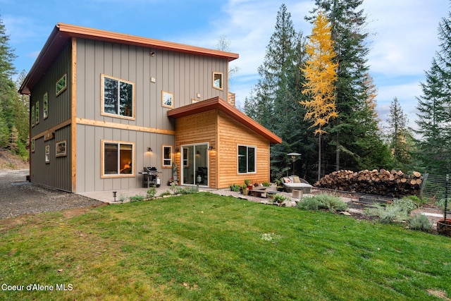 rear view of property with a patio area and a lawn