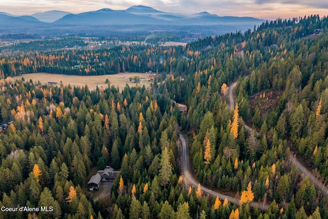 aerial view at dusk featuring a mountain view