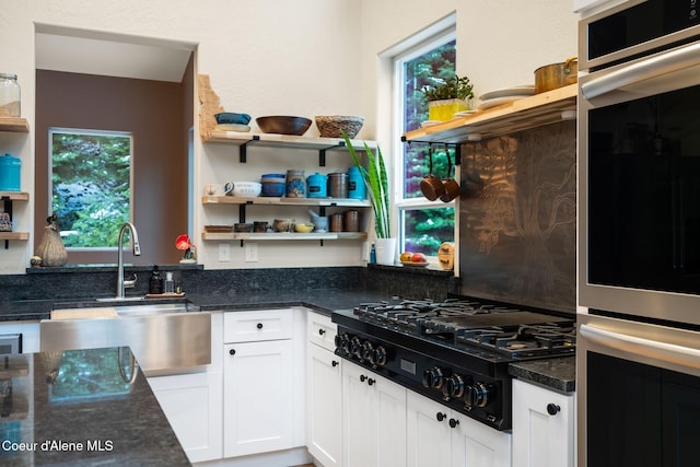 kitchen with white cabinetry, black gas stovetop, plenty of natural light, and sink