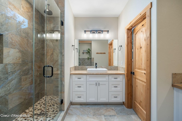 bathroom featuring vanity and an enclosed shower