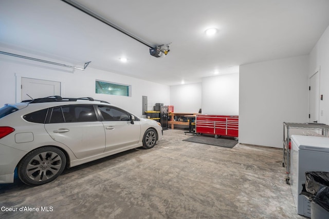 garage with electric panel and a garage door opener