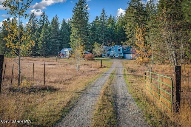 14895 N Crystal Springs Ln, Rathdrum, ID 83858 - view of dirt / gravel road with a view of trees, a gated entry, and a view of rural / pastoral area