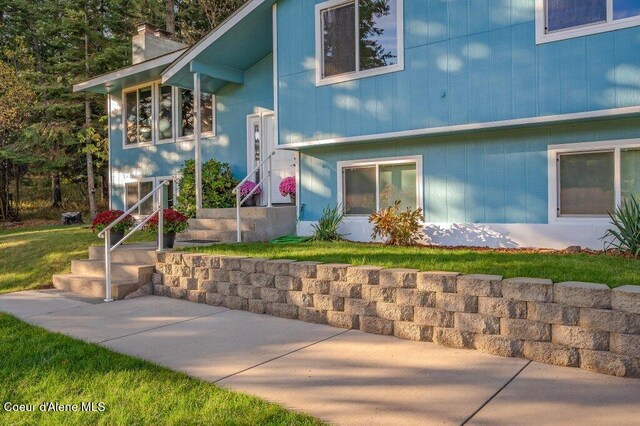 14895 N Crystal Springs Ln, Rathdrum, ID 83858 - view of front of home with a chimney and a front yard