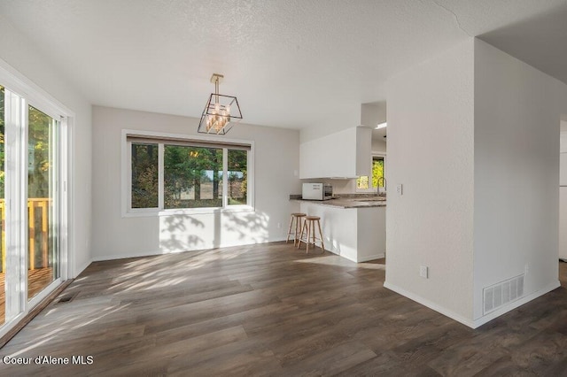 14895 N Crystal Springs Ln, Rathdrum, ID 83858 - unfurnished dining area with plenty of natural light, dark wood-style floors, and baseboards