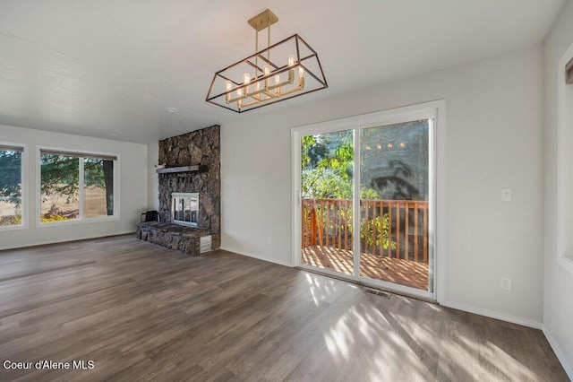 14895 N Crystal Springs Ln, Rathdrum, ID 83858 - unfurnished living room featuring healthy amount of natural light, a chandelier, wood finished floors, and baseboards