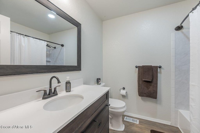 14895 N Crystal Springs Ln, Rathdrum, ID 83858 - full bath featuring vanity, wood finished floors, toilet, baseboards, and shower / bath combination with curtain