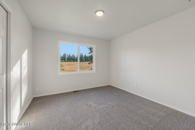 14895 N Crystal Springs Ln, Rathdrum, ID 83858 - spare room featuring carpet floors and baseboards