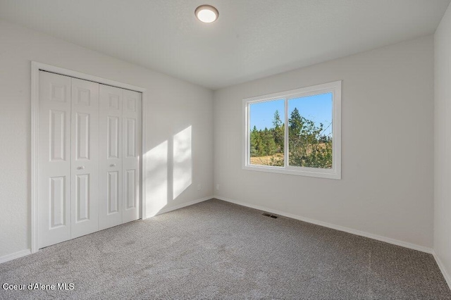 14895 N Crystal Springs Ln, Rathdrum, ID 83858 - unfurnished bedroom with carpet flooring, a closet, and baseboards