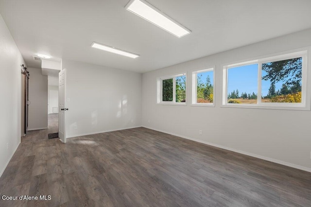 14895 N Crystal Springs Ln, Rathdrum, ID 83858 - empty room with dark wood-style floors and baseboards