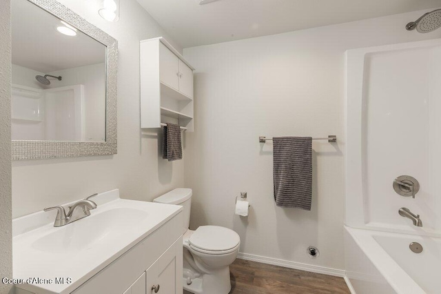 14895 N Crystal Springs Ln, Rathdrum, ID 83858 - full bath with wood finished floors, vanity, toilet, shower / bath combination, and baseboards