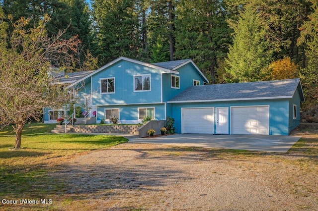14895 N Crystal Springs Ln, Rathdrum, ID 83858 - view of front of house with driveway, an attached garage, a front yard, and a shingled roof