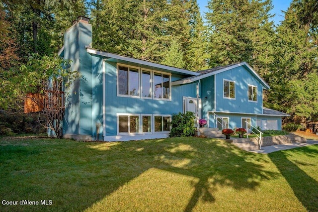 14895 N Crystal Springs Ln, Rathdrum, ID 83858 - rear view of property with a lawn and a chimney