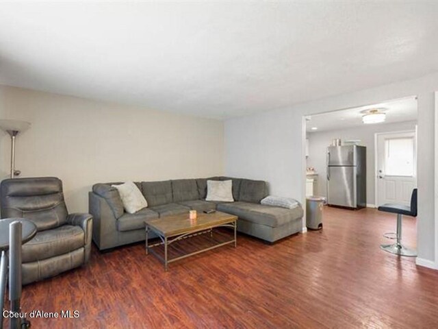 living room with dark hardwood / wood-style flooring