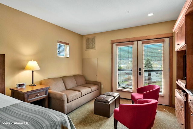 carpeted bedroom featuring access to outside and multiple windows