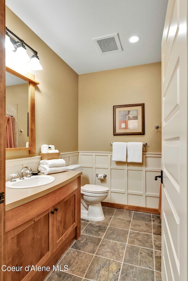 bathroom featuring vanity and toilet