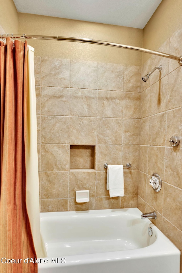 bathroom with shower / tub combo with curtain