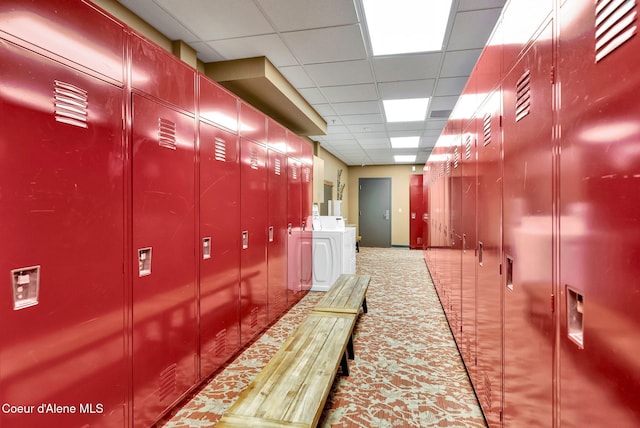 hallway with a paneled ceiling