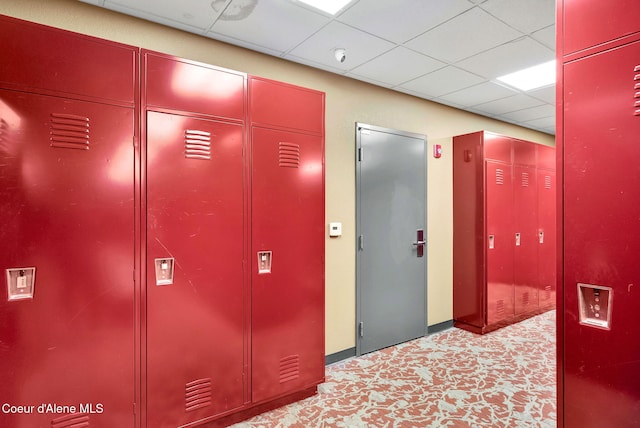 corridor with a paneled ceiling