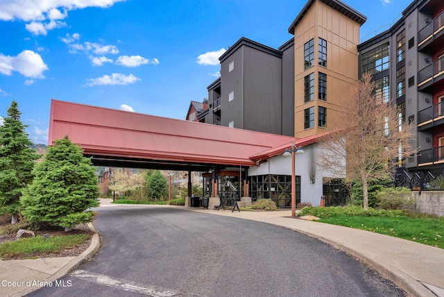 view of building exterior featuring central AC and a carport