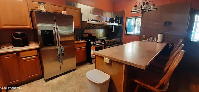 kitchen with stainless steel appliances, extractor fan, hanging light fixtures, an inviting chandelier, and a center island