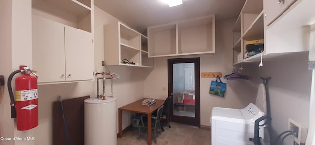 laundry room featuring water heater, washer / clothes dryer, and cabinets