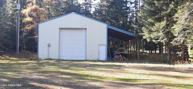 view of outbuilding with a garage and a carport