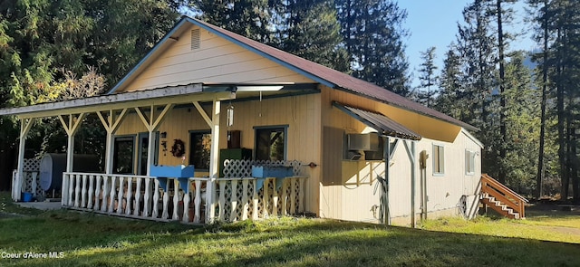 exterior space featuring a yard and covered porch