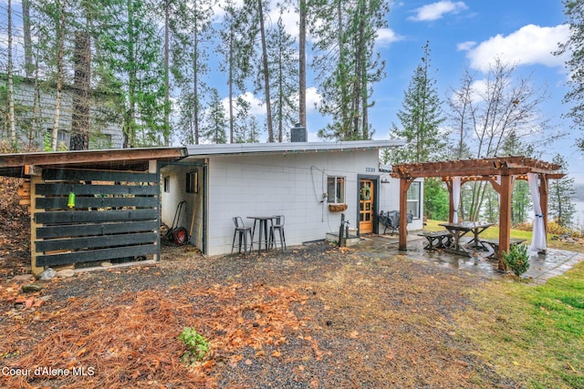 back of property featuring a pergola