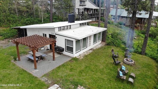 back of property featuring a pergola, a patio area, cooling unit, and a fire pit