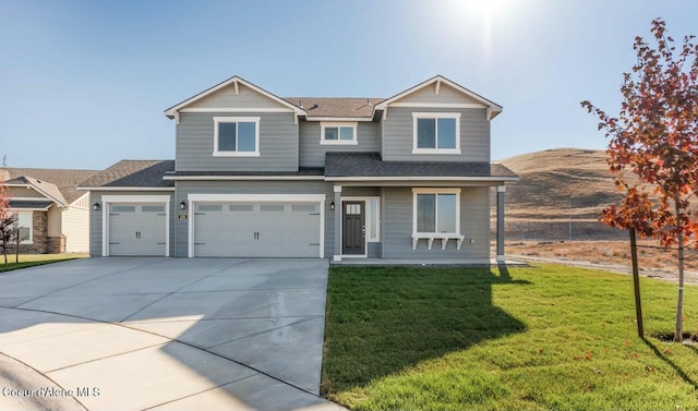 view of front of home with a garage and a front yard