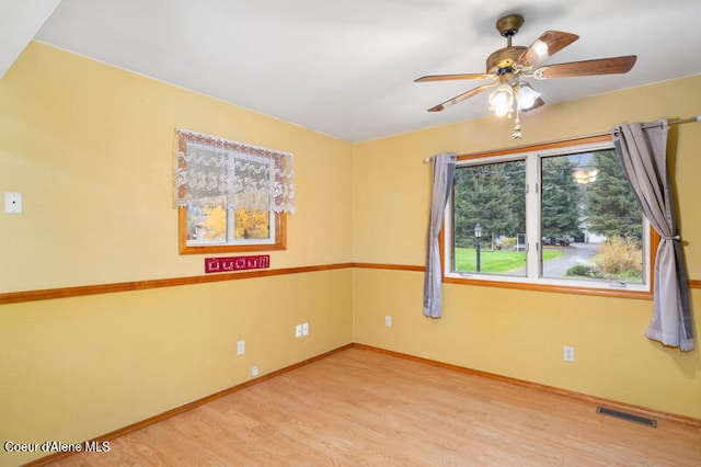 unfurnished room featuring ceiling fan and hardwood / wood-style flooring