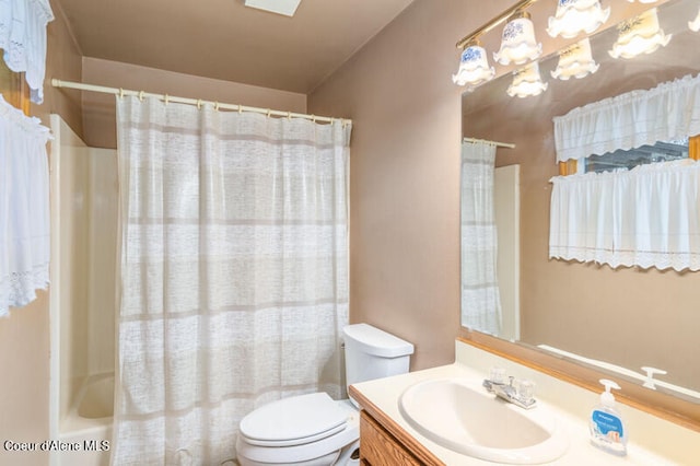 full bathroom with vanity, shower / bath combo, and toilet