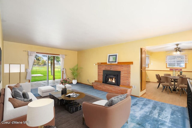 living room with light hardwood / wood-style flooring and ceiling fan