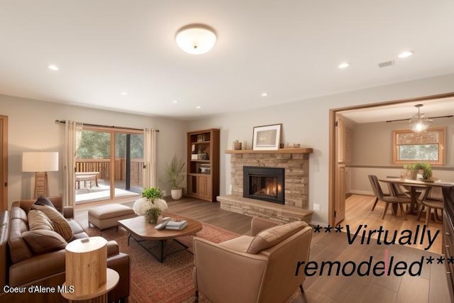 living room with light hardwood / wood-style floors and a fireplace