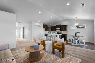 living room featuring light hardwood / wood-style floors and vaulted ceiling