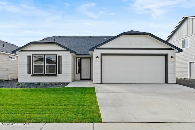 single story home featuring a garage and a front yard