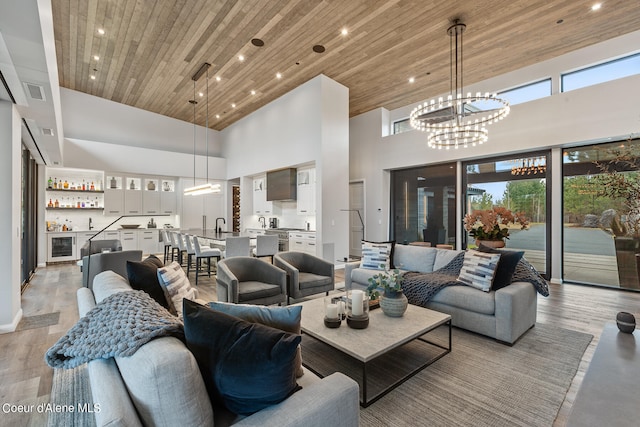 living room with high vaulted ceiling, light wood-type flooring, and wood ceiling