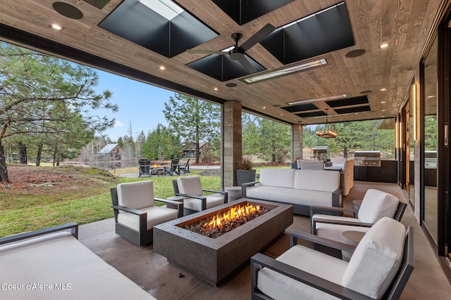 view of patio / terrace with an outdoor living space with a fire pit, area for grilling, an outdoor kitchen, and ceiling fan