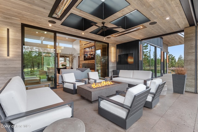 view of patio with an outdoor living space with a fire pit and ceiling fan