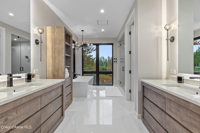 bathroom with tile patterned floors, vanity, shower with separate bathtub, and a notable chandelier