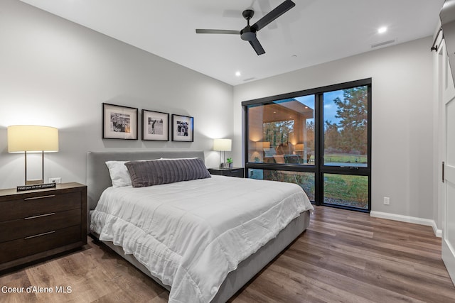 bedroom with hardwood / wood-style floors and ceiling fan