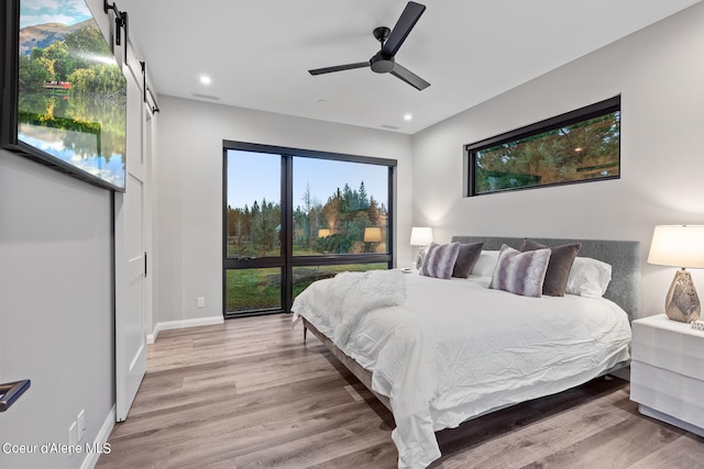 bedroom with hardwood / wood-style floors and ceiling fan