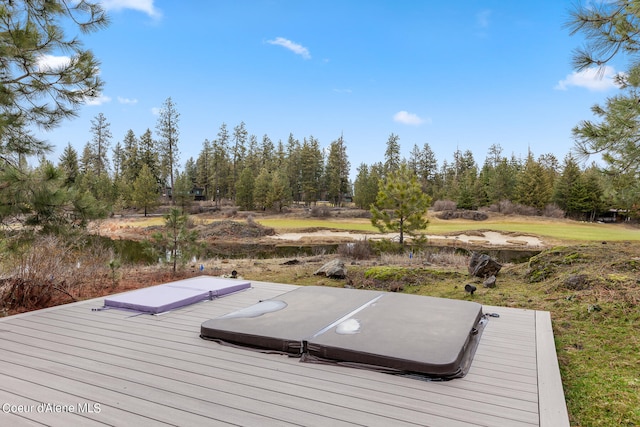 deck with a covered hot tub