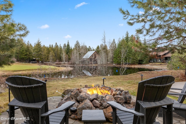 view of yard with a water view and an outdoor fire pit