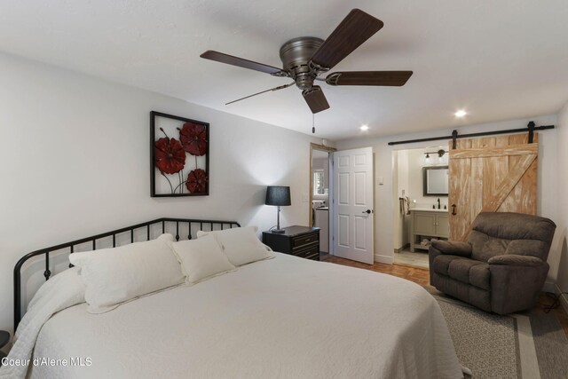 431 E Sunnyside Rd, Sandpoint, ID 83864 - bedroom featuring a barn door, baseboards, connected bathroom, recessed lighting, and ceiling fan