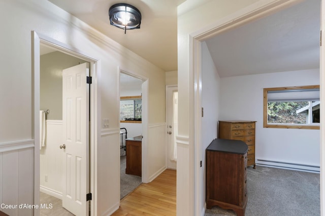 431 E Sunnyside Rd, Sandpoint, ID 83864 - hallway with a baseboard radiator, light wood finished floors, and a wainscoted wall