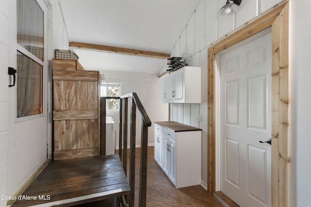 kitchen featuring lofted ceiling with beams, dark hardwood / wood-style floors, and white cabinetry