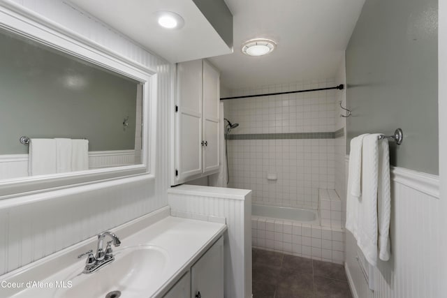 bathroom with tile patterned flooring, vanity, and tiled shower / bath combo